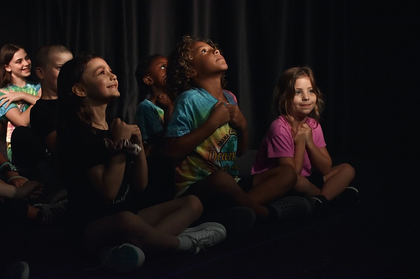 Ember Bly, 5, Avenn Zarchev-Miller, 7, and Brooklyn Koenreich, 5, prepare to blast off into space.