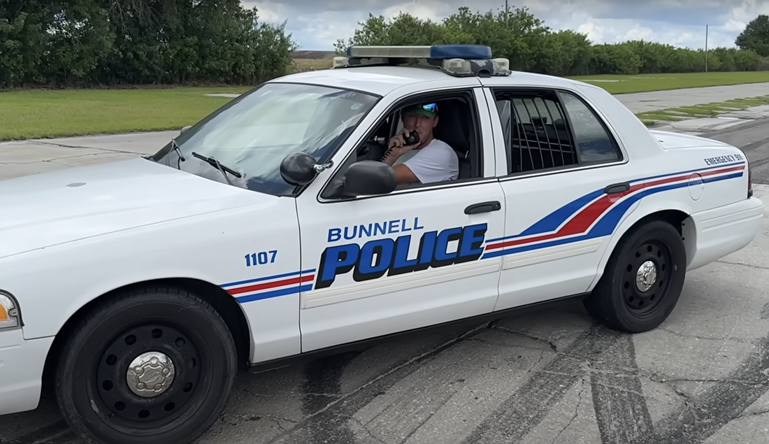 YouTuber Cleetus McFarland in a BPD police cruiser he purchased. Image screenshot from McFarland's YouTube video