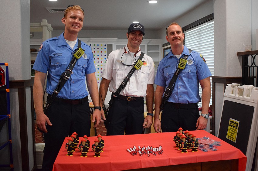 East Manatee Fire Rescue's Gabriel Yoder, Eric Hoying and Brett Burchenne interact with residents at Cypress Springs Gracious Retirement Living.