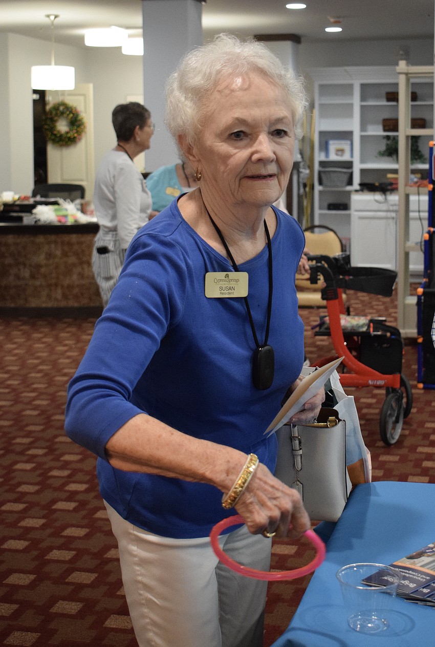 Susan McClure wins a prize in a ring toss for Bright Star Care. McClure walked away from the health fair with plenty of goodies from vendors and game prizes.