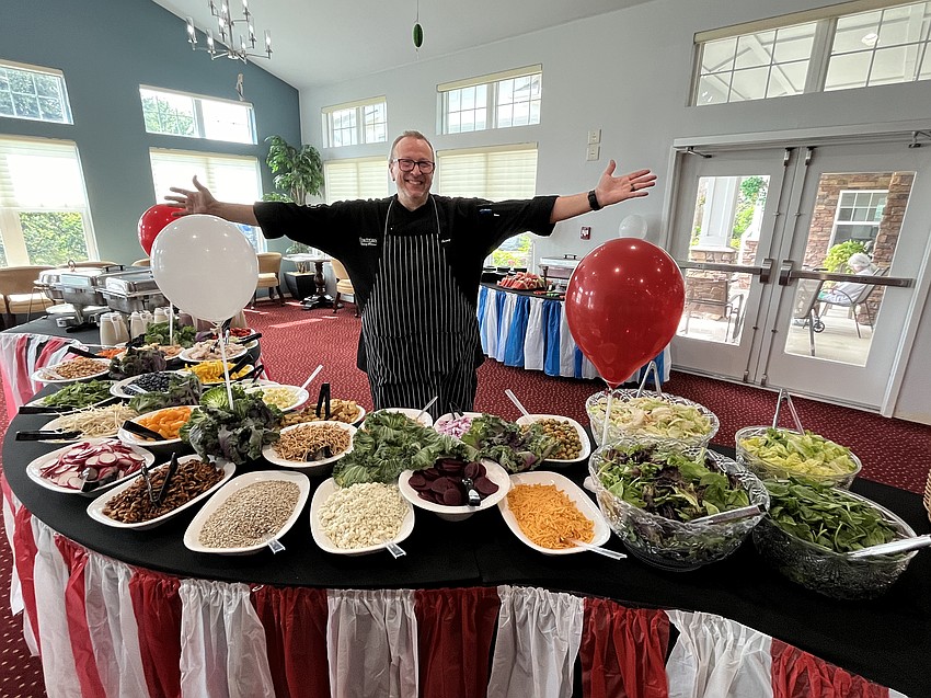 Darin Jarosz, the executive chef at Cypress Springs Gracious Retirement Living, prepares a salad bar for residents as part of the health fair.