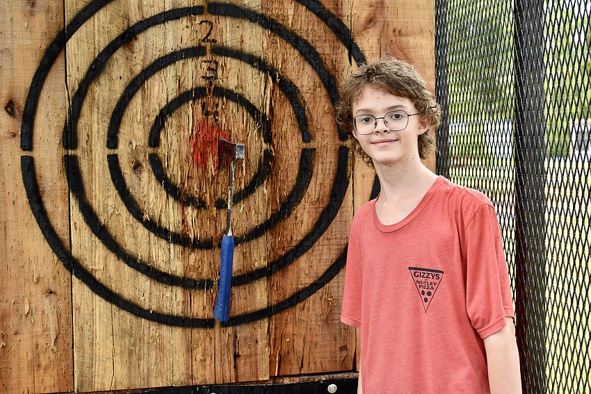 Pasco County resident Raymond Hartfield gets a bullseye in the axe throwing truck.