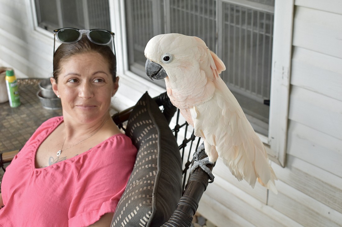 Teresa Salinas and Puppy sit together on the porch, where Puppy normally sits with Greg Para while he has his morning coffee.