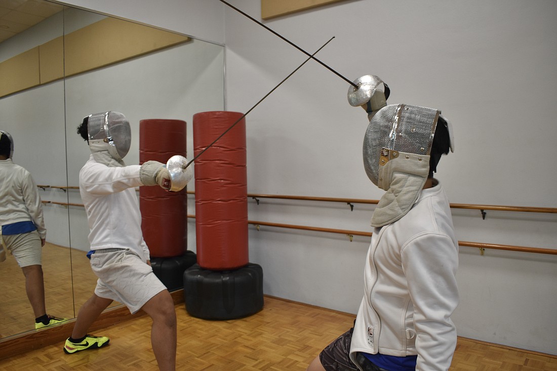 Mark Vu, 13 and his brother Matthew Vu, 16, practice at SRQ Fencing Club.