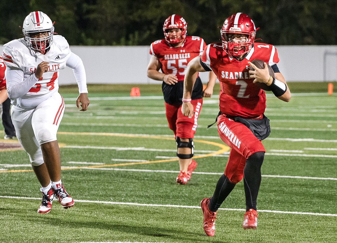 Hayden Hayes (2), running a quarterback keeper last season, has traded Seabreeze red for Flagler Palm Coast green this year. File photo by Michele Meyers