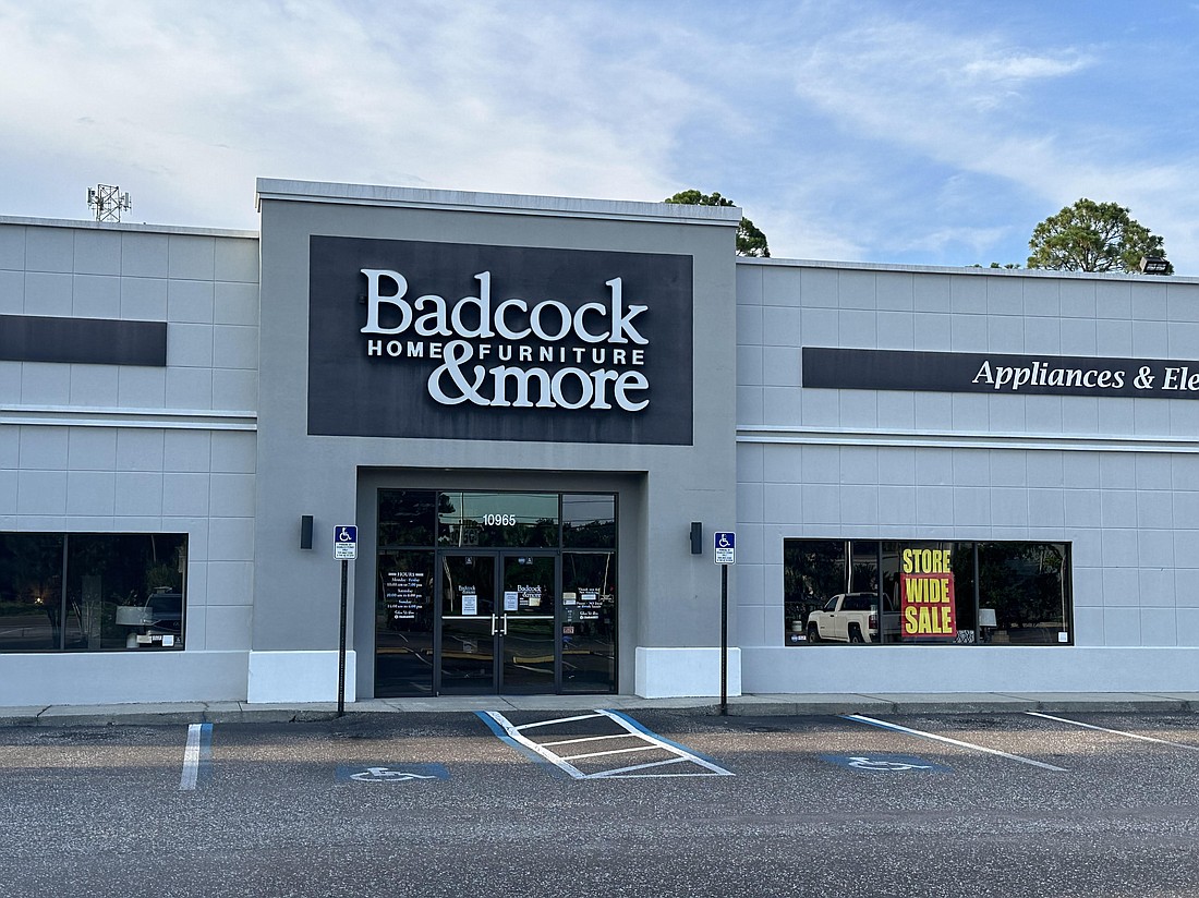 Signs visible from outside the Badcock Home Furniture & More store at 10965 Beach Blvd. say "Storewide Sale," but inside the signs also say "Store Closing."