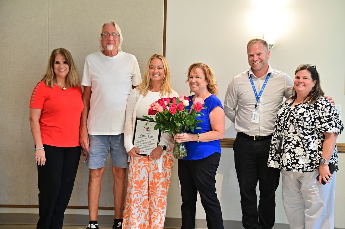 Community Center Supervisor Carrie Todd (center) at a ceremony held in her honor. Courtesy photo