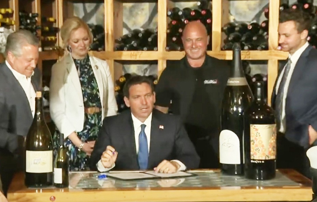 Florida Gov. Ron DeSantis signs the bill March 28 allowing for the sales of large wine bottles. They can now hold as much as 15 liters.