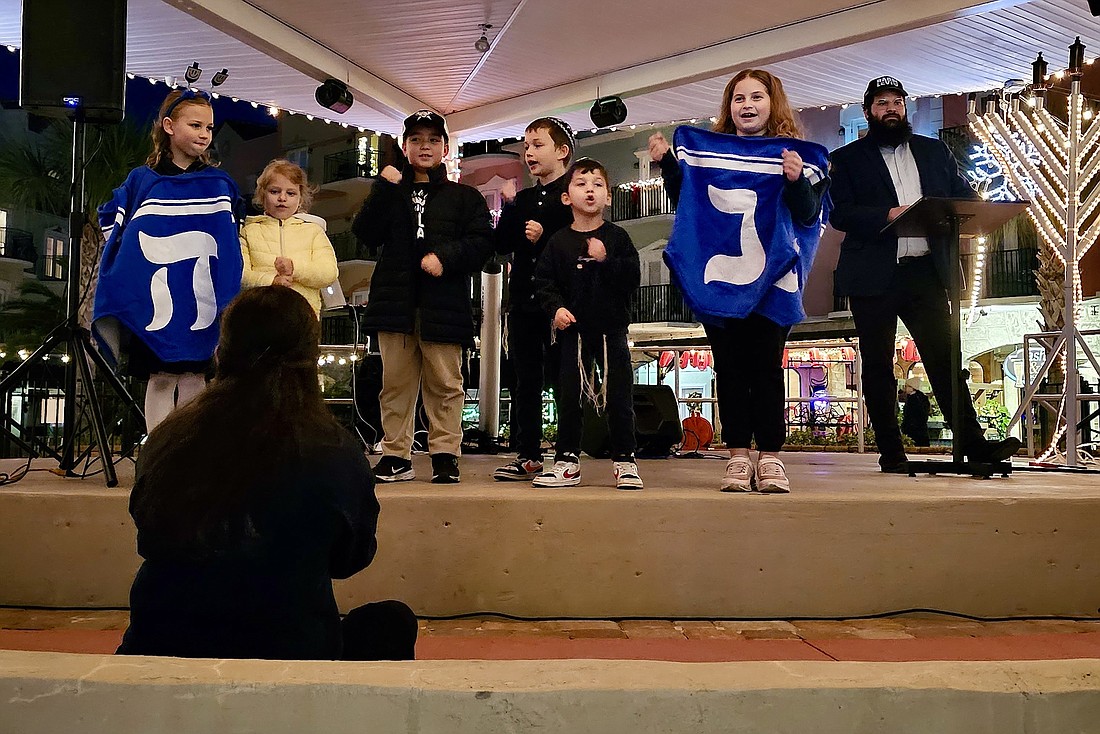 Students from Chabad Hebrew School sing songs during Chabad Jewish Center of Palm Coast's Hannukah celebration at European Village last year. File photo by Sierra Williams