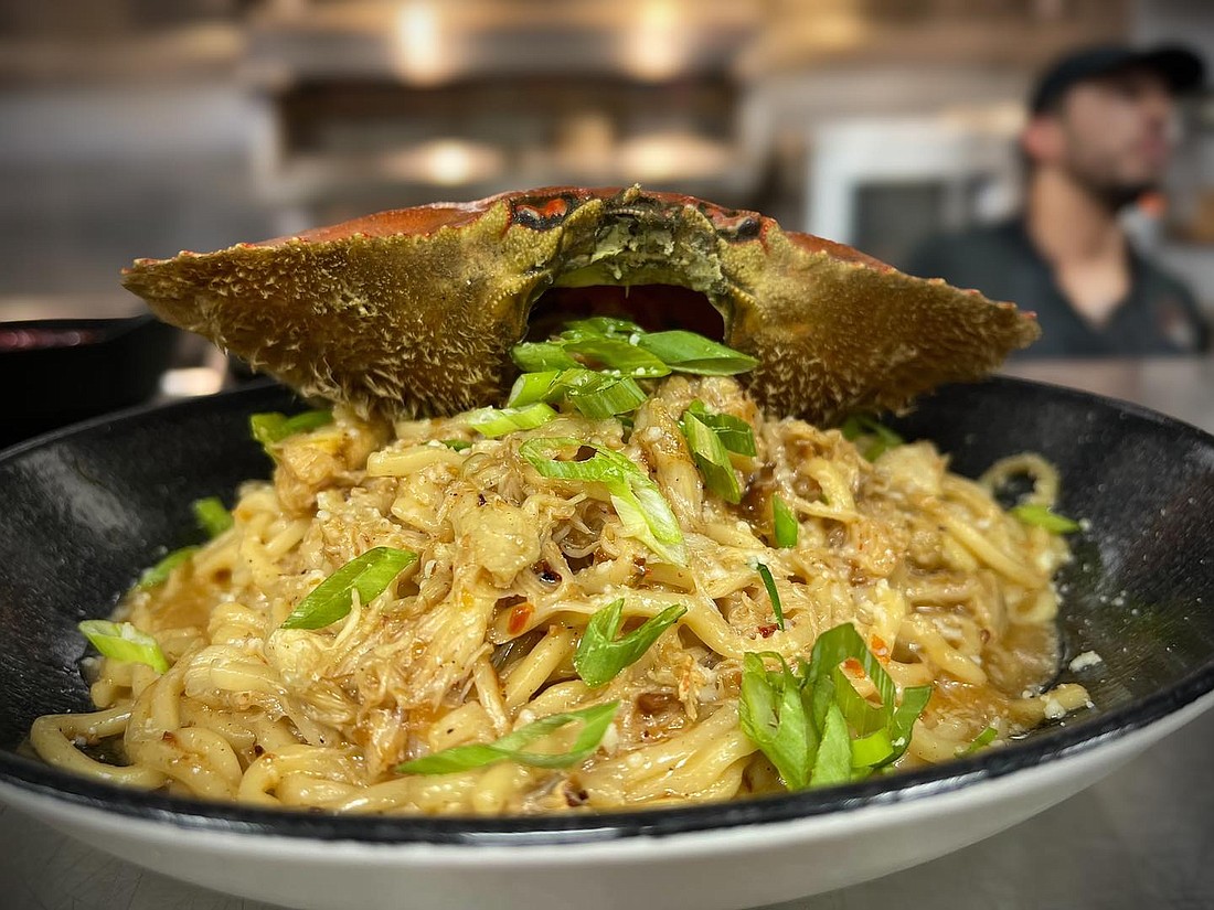 Fuego Comida's chef special: Mexico City garlic noodles ($25+) dished out with whole Dungeness crab (market price).