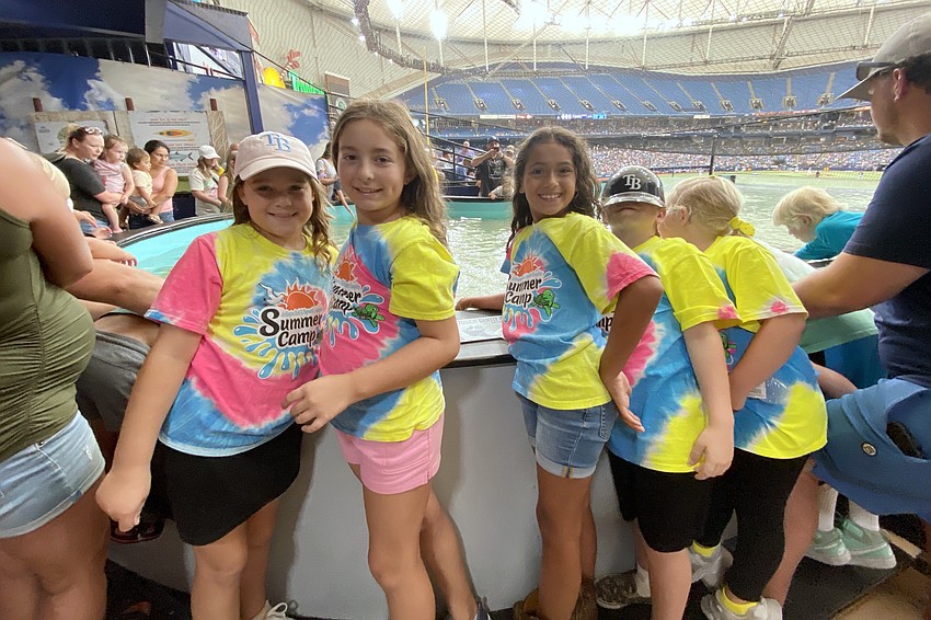 Violet Bartolone, 8, Evelyn Lambert, 9 and Hazel Houser, 7 enjoy the rays touch tank at the Tampa Bay Rays stadium on July 31.