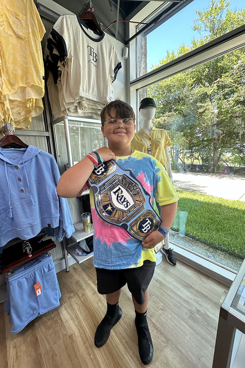 Cooper Johs (11), finds a souvenir from the Tampa Bay Rays game on July 31.