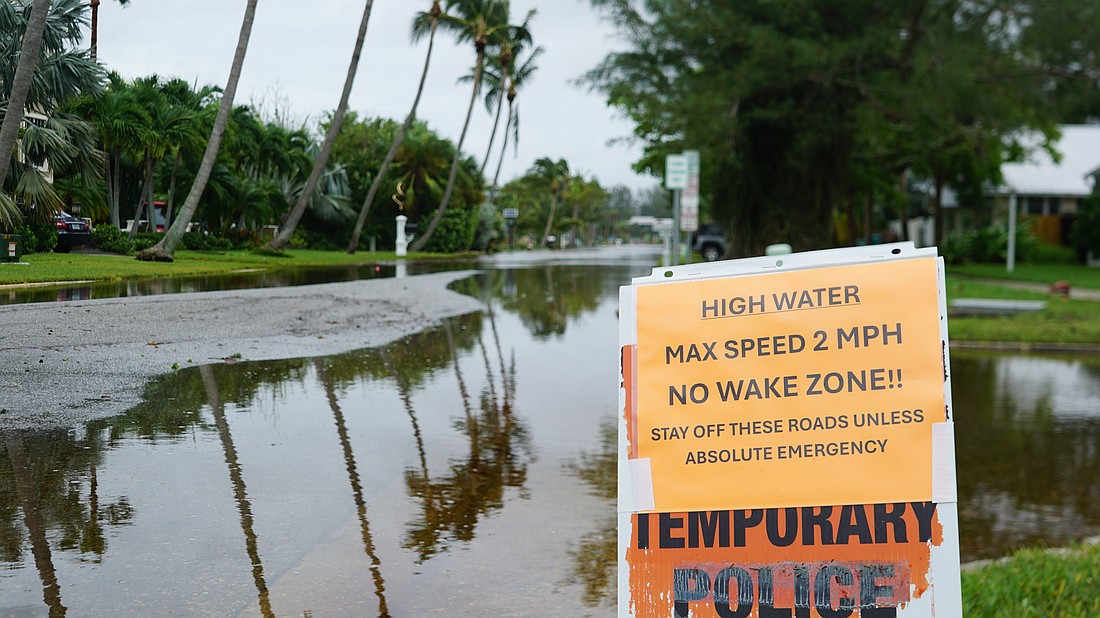 A sign in the north-end Village warns drivers of high water after Hurricane Debby passed Longboat Key.