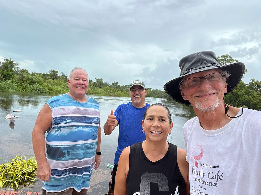Denny Pyeatt, Mario Diaz, Adriana Diaz and Jack Boenau are Quonset Road neighbors who went door-to-door to make sure everyone on their flooded street was safe.