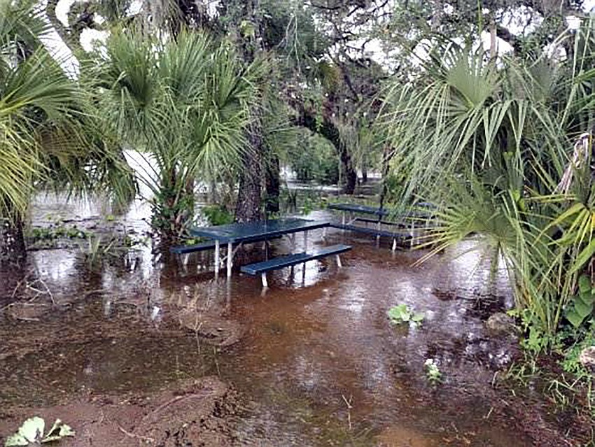 The water nears to Linger Lodge Restaurant, starting to swallow an outdoor eating area.