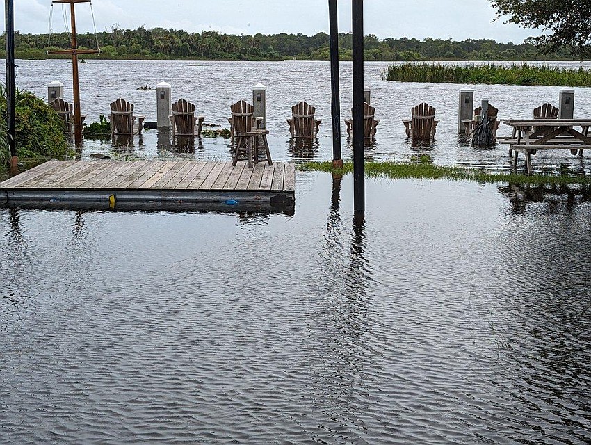 Waters from the Evers Reservoir swell over the docks and almost engulf the stage at Jiggs Landing after Hurricane Debby pounded the area with rain.
