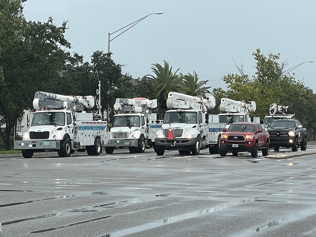 FPL and Pike electric trucks at Tuttle Avenue and Fruitville Road head out on their calls on Aug. 5, 2024, following Hurricane Debby.