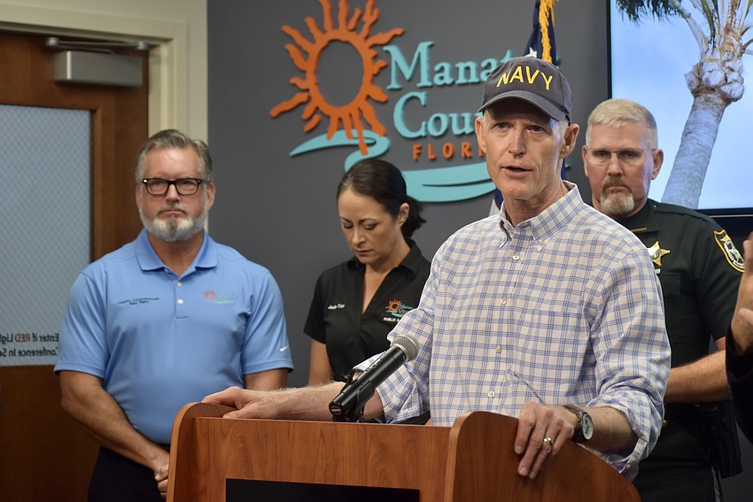 Senator Rick Scott speaks at the Manatee County Emergency Operations Center on Aug. 6. Behind him from left to right are Commissioner Mike Rahn, Director of Public Safety Jodie Fiske and Sheriff Rick Wells.