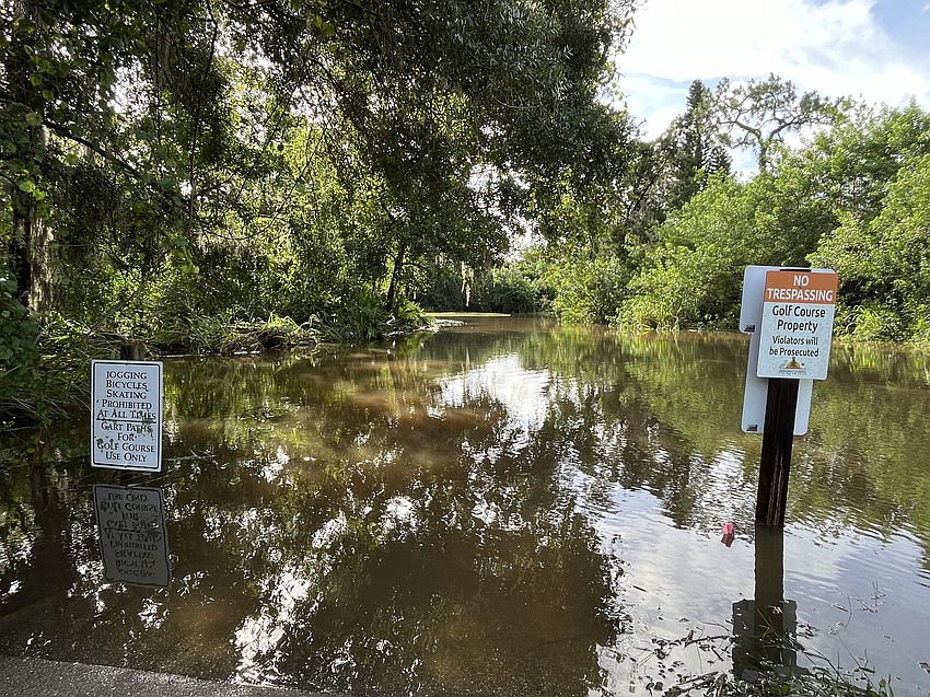 Bikers, joggers and skaters usually are warned not to be on the River Club Golf Course, but Tuesday they would have needed a boat after Hurricane Debby.
