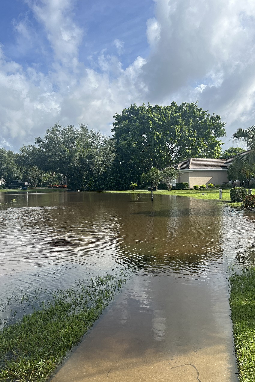 Water engulfs Riversedge Street Circle in River Club.