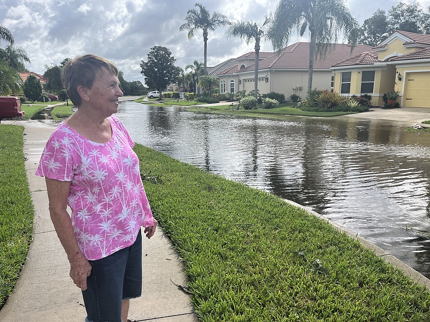River Club's Mary Ilcym says the water on Royal Lytham Avenue is keeping her from leaving her home Tuesday.