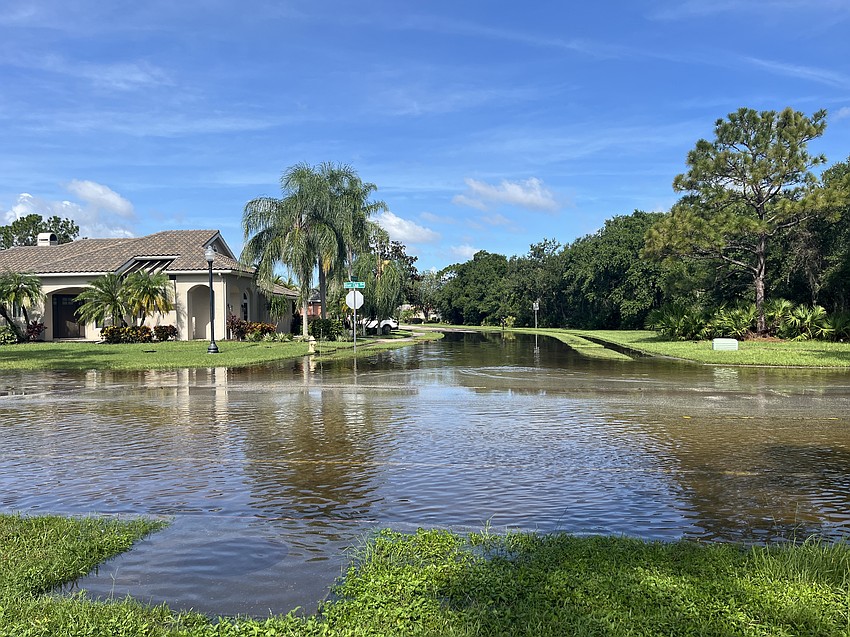 The intersection of River Club Boulevard and Royal Lytham Avenue remains flooded at 10 a.m. Tuesday. By 1 p.m. the water cleared enough for people to safely drive past.