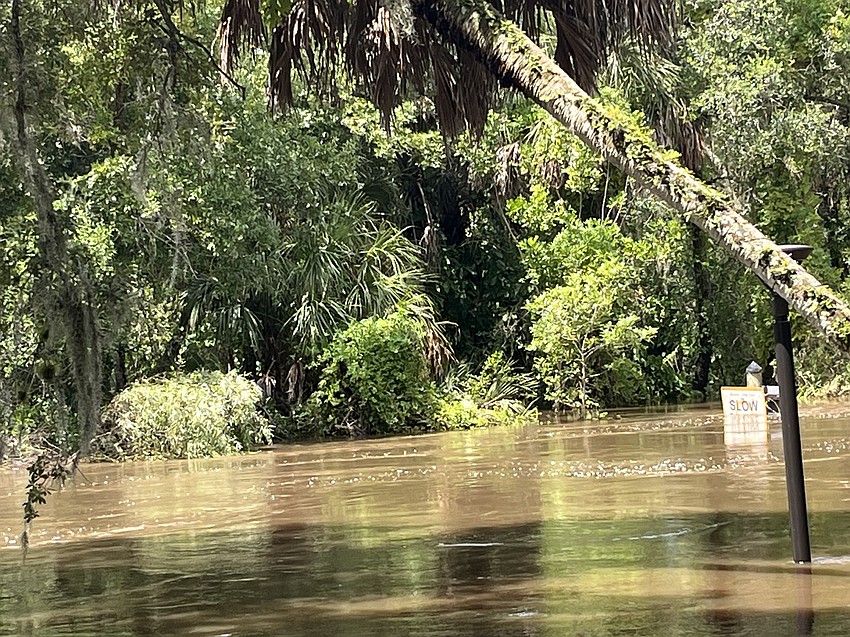 Peggy Shonga, an administrator for Linger Lodge, says the sign shown here in the Braden River wasn't visible Monday as Hurricane Debby swelled.