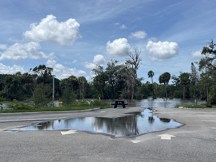 A puddle remains in front of the Linger Lodge restaurant after the water from the Braden River recedes.