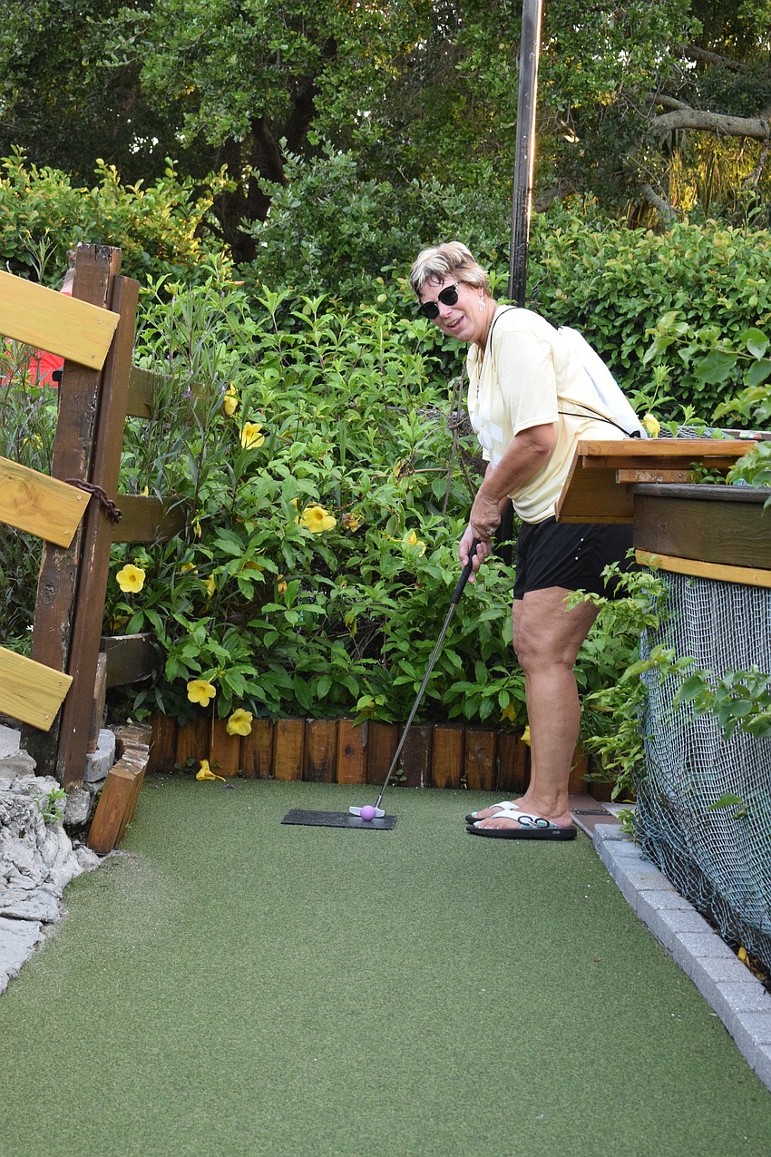 Lakewood Ranch's Kelly Harmon tees off. Between holes, she danced and joked with other golfers.