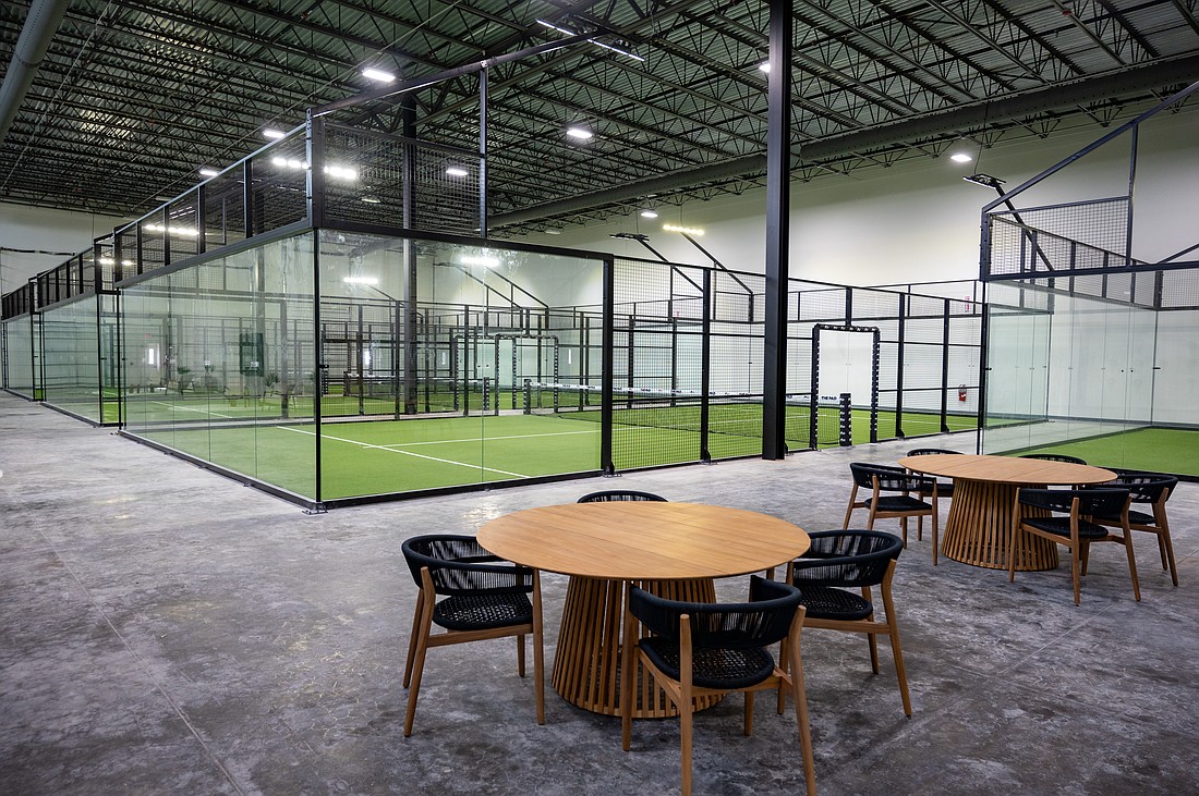 Padel courts feature walls, mesh and high ceilings.