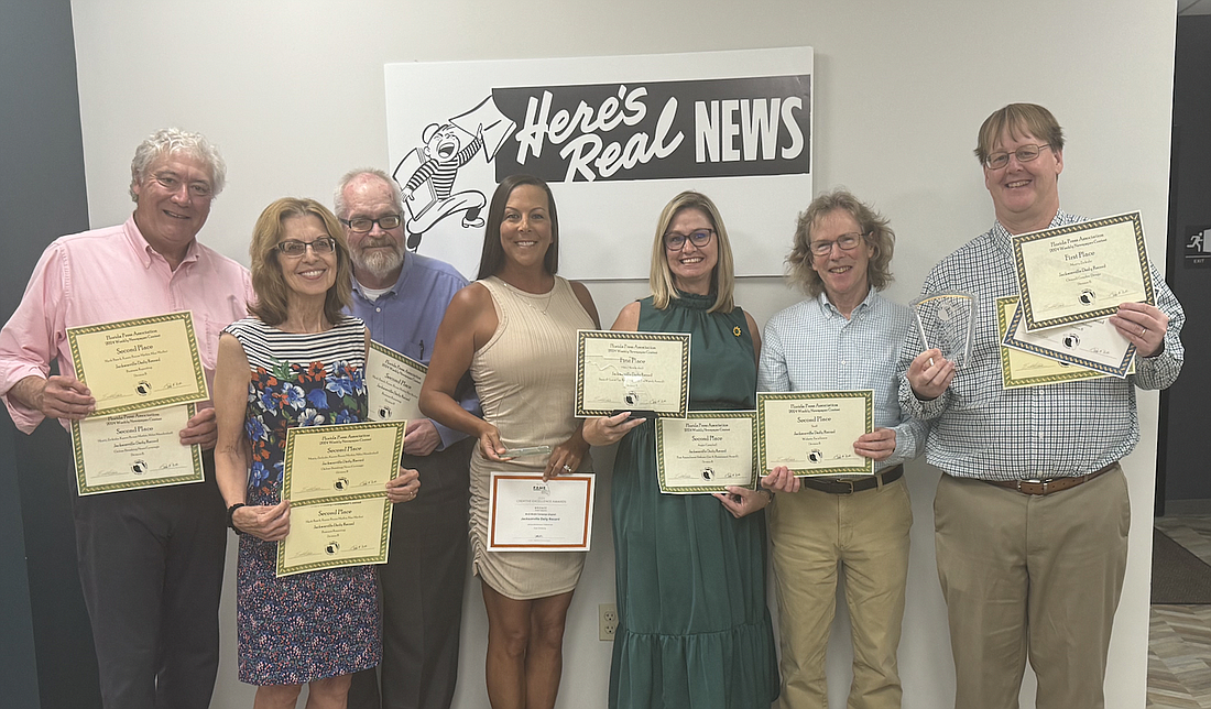 Jacksonville Daily Record staff members show off their awards. From left, Dan Macdonald, Karen Brune Mathis, Max Marbut, Codi Gildberg, Angie Campbell, David Crumpler and Monty Zickuhr. Award-winners not pictured are Ric Anderson, Mark Basch, Scott Sailer and former Daily Record reporter Mike Mendenhall.