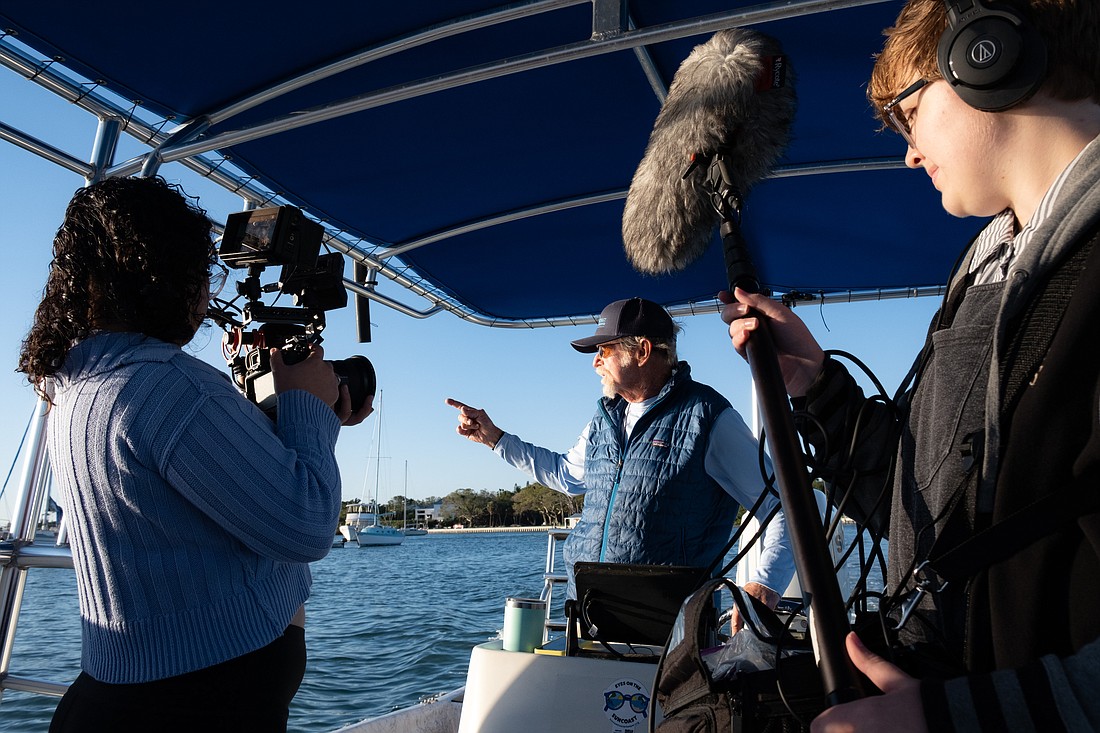 Alejandra Cintron Rivera (left) and Ella Satterfield (right) help film the short documentary about Sister Keys featuring Rusty Chinnis (center).