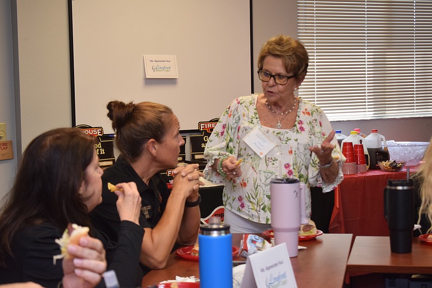 Carol Peschel chatting Tina Adams and Lisa Boggs