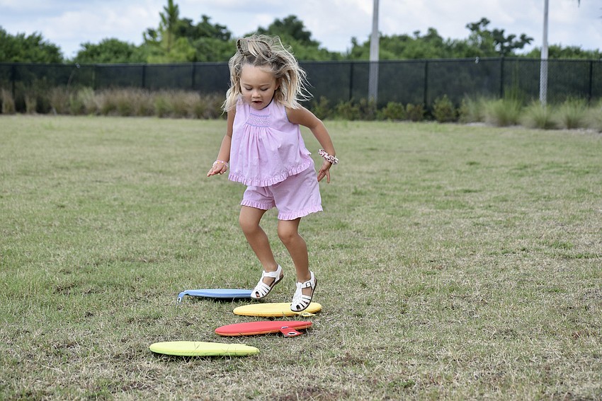 Parrish resident Isla Robley, 3, hops through the course like she's done this before.