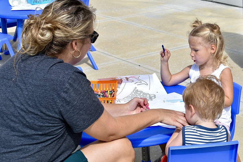 Myakka resident and mom, Jaimie Suggs, colors with 1-year-old Warren and 2-year-old Ada Suggs after the games.