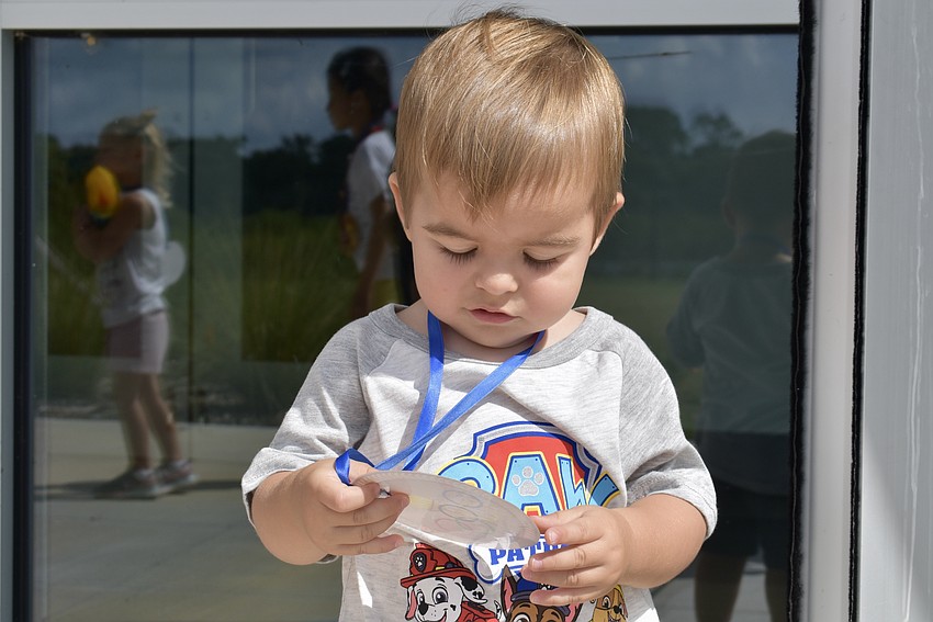 Lakewood Ranch resident Nicholas Monzine admires his medal.