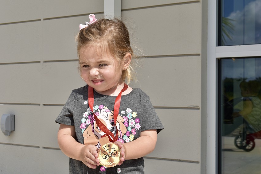 Lakewood Ranch resident Natalia Nicholas shows off her Toddler Olympics medal.