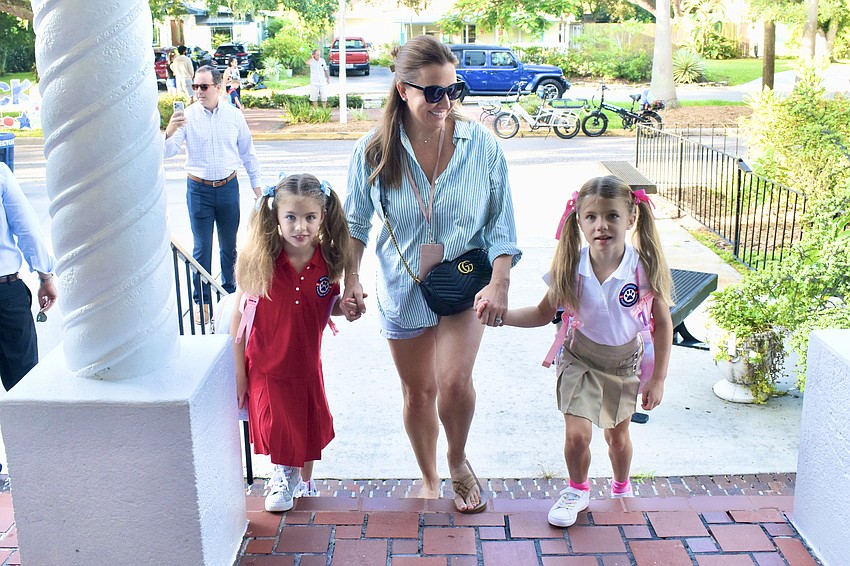 Second grader Ellie Biter, Molly Biter and second grader Maya Biter take their first steps into the school year at Southside Elementary.