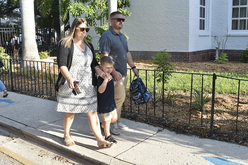 Ashleigh Davis, kindergartener Hayes Davis and Eric Davis approach Southside Elementary.