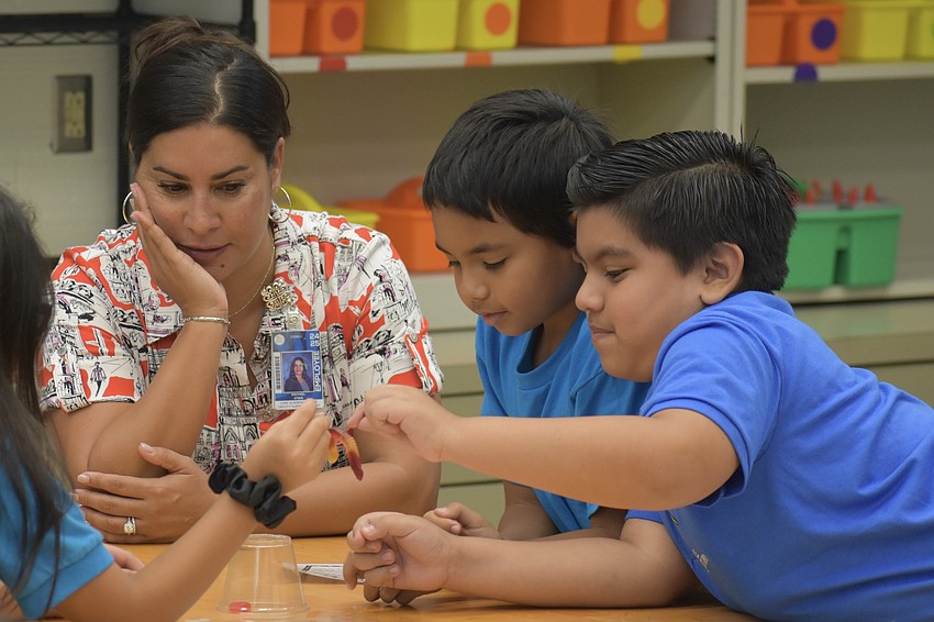 Deputy Superintendent and Chief Academic Officer of Sarasota County Schools Rachael O’Dea, Anthony Paga and Erick Villalobos-Pedraz perform the 