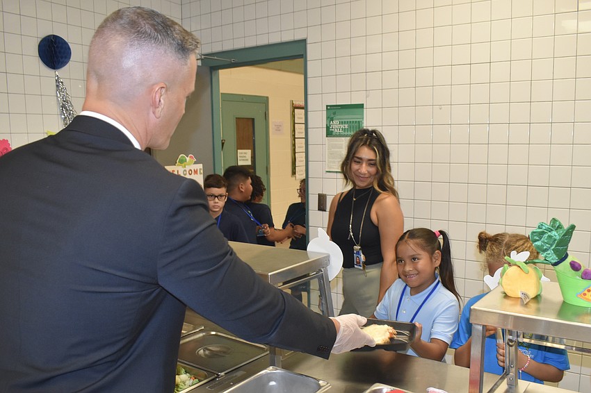Superintendent Terry Connor, second grade teacher Nohemi Hall and her student Jasmin Lopez enjoy the arrival of lunchtime at Tuttle Elementary.