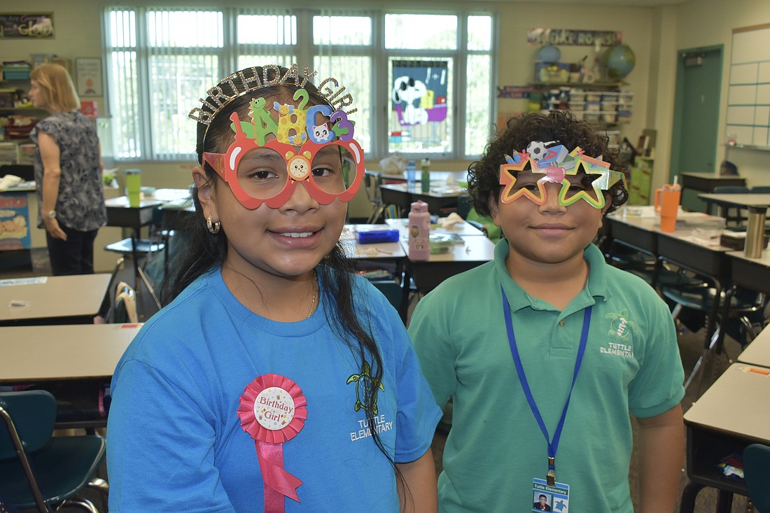 Fifth graders Miranda Morales Briceno and Janyl Alvarado Hernandez wear special back-to-school glasses in fifth grade science teacher Justine Holcomb's class at Tuttle Elementary.