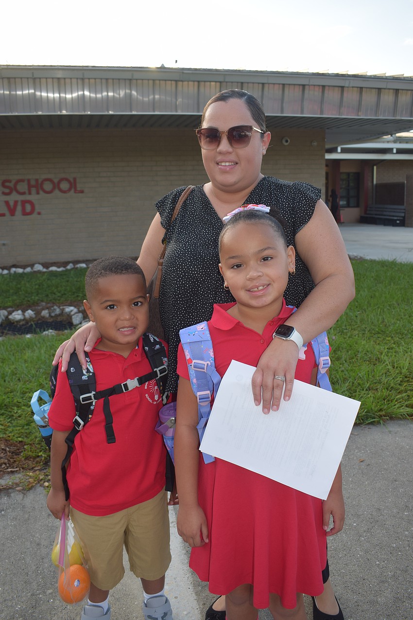Marie Williams and her children, kindergartner Azavier Williams and second grader Alana Williams, are ready for the first day of school. Marie Williams says Alana Williams couldn't sleep because she was so excited.