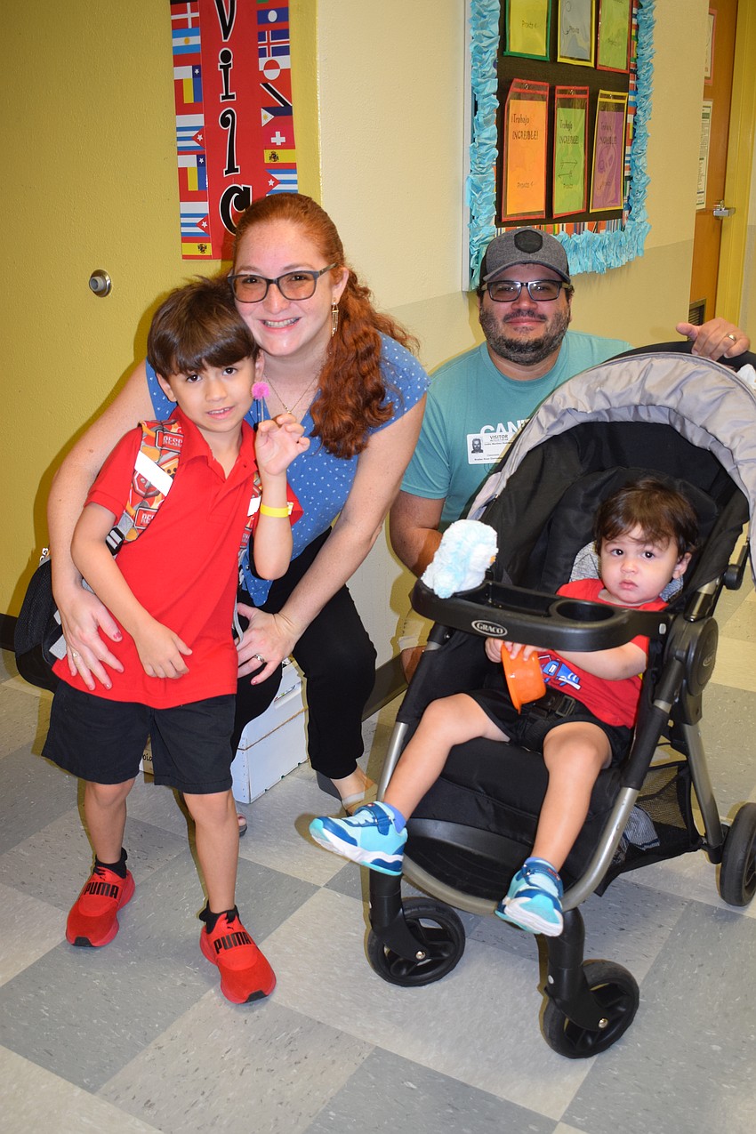 Tomas Martinez-Bartolomei prepares to say goodbye to his mother, Carolina Bartolomei, father, Emilio Martinez, and brother, Liam Martinez-Bartolome, before entering his dual language kindergarten classroom at Braden River Elementary School.