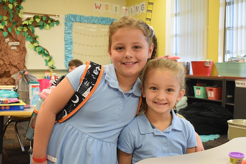 Braden River Elementary School first grader Charlotte Casey says goodbye to her little sister Juliana Casey as she's dropped off in her kindergarten classroom.