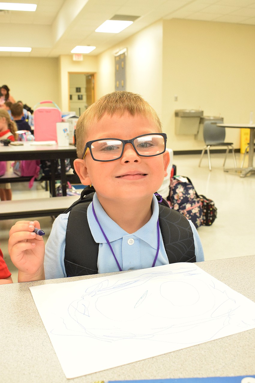 Henry Falanga takes time to color before heading off to the classroom for his first day of pre-K at Braden River Elementary School.