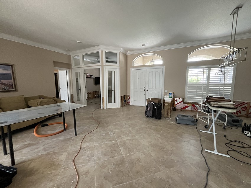 Nicole Eveloff's River Club home is emptied out to make way for fans to dry out the floors after Hurricane Debby flooded the home.