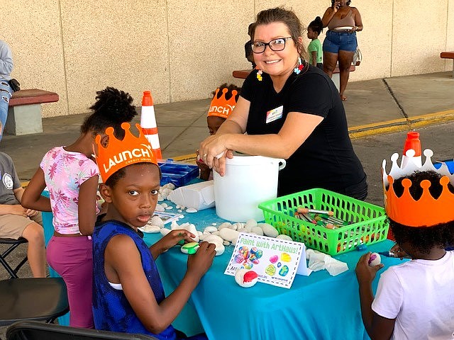 ArtHaus Executive Director Cameron Vintson helps kids with art projects during the Threads of Compassion event. Courtesy photo