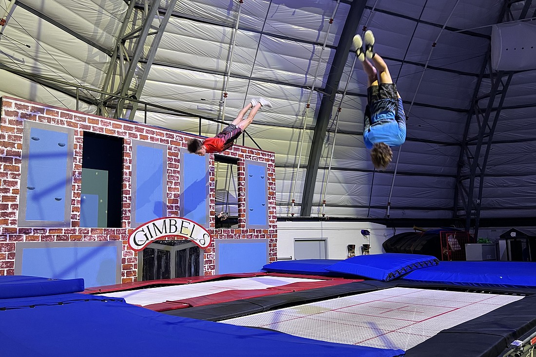 Students jump on the trampoline.