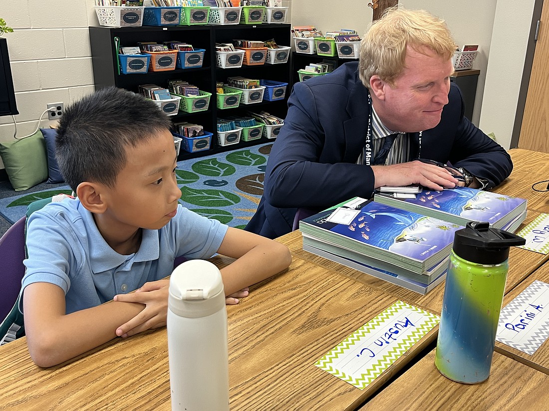 Austin Chen, a Robert E. Willis Elementary School fourth grader, and Superintendent Jason Wysong are fully engaged on a group discussion about careers relating to science.